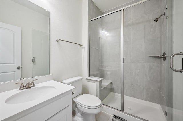 bathroom with vanity, toilet, and an enclosed shower