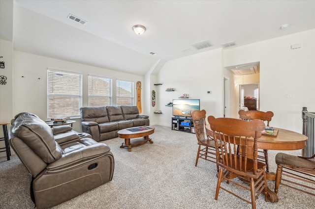 carpeted living room featuring lofted ceiling