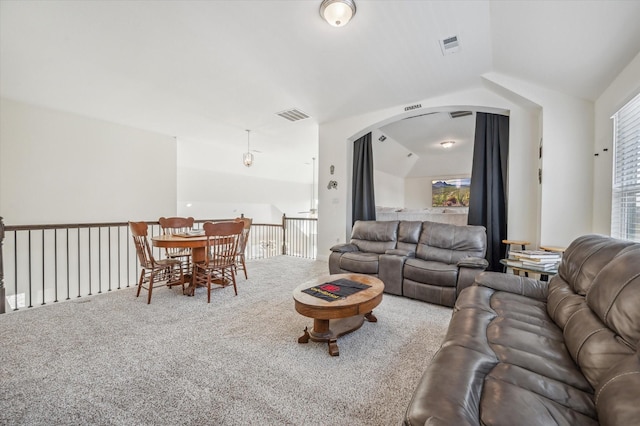 carpeted living room featuring a healthy amount of sunlight and lofted ceiling