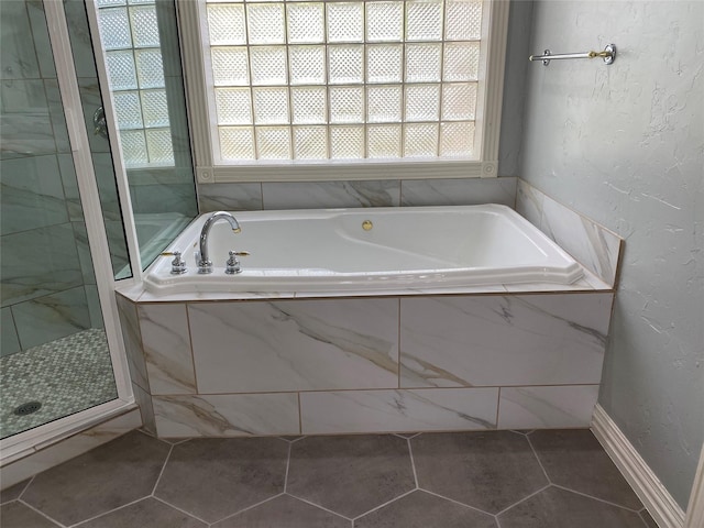 bathroom featuring tile patterned floors and separate shower and tub