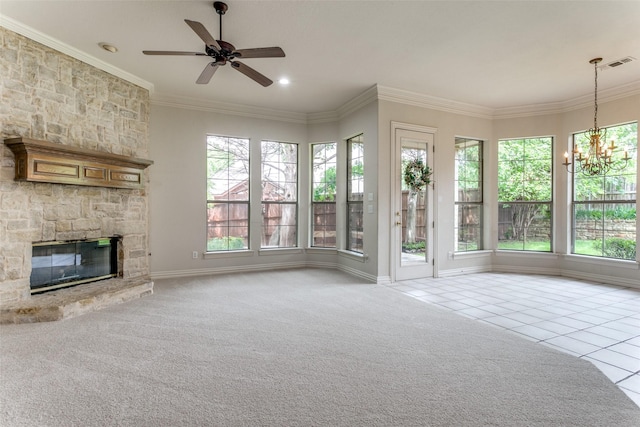 unfurnished living room with crown molding, a fireplace, ceiling fan with notable chandelier, and light tile patterned flooring