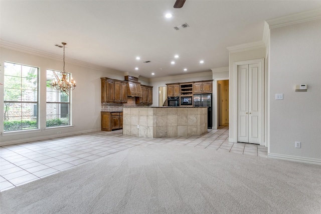 kitchen featuring ornamental molding, black fridge, light colored carpet, and decorative light fixtures