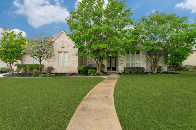 view of property hidden behind natural elements with a front yard