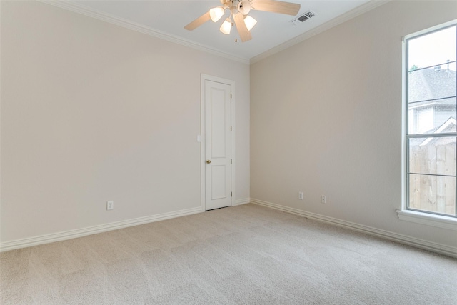 carpeted empty room with crown molding and ceiling fan