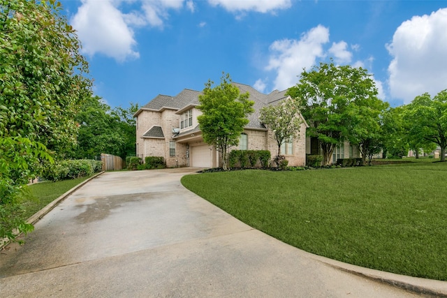 french country inspired facade featuring a garage and a front lawn