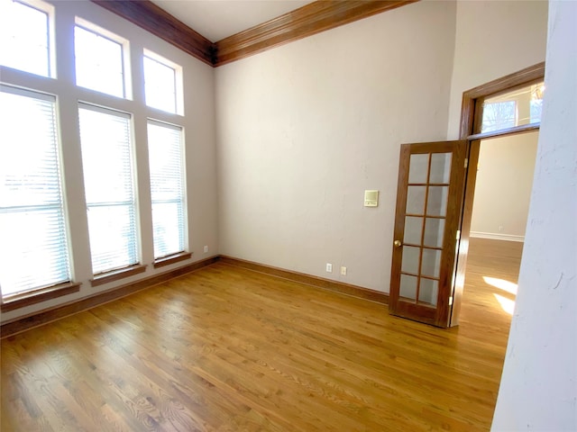 empty room featuring hardwood / wood-style flooring and ornamental molding