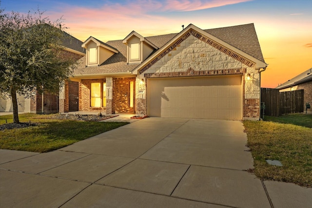 view of front of home with a yard and a garage