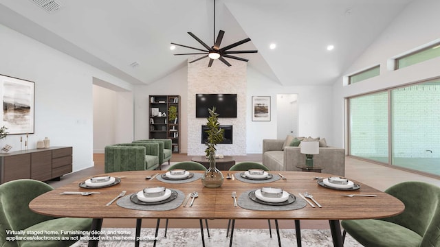 dining space featuring visible vents, a fireplace, high vaulted ceiling, recessed lighting, and a ceiling fan