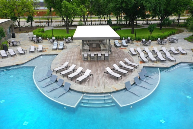 view of swimming pool featuring a bar