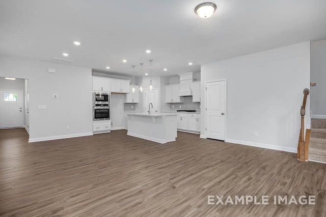 unfurnished living room featuring dark hardwood / wood-style floors and sink