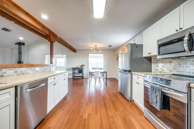 kitchen with decorative backsplash, light wood-type flooring, white cabinets, and appliances with stainless steel finishes