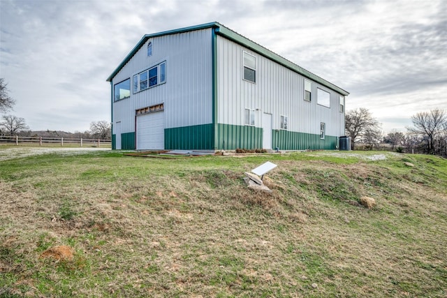 view of side of home with a yard and central air condition unit