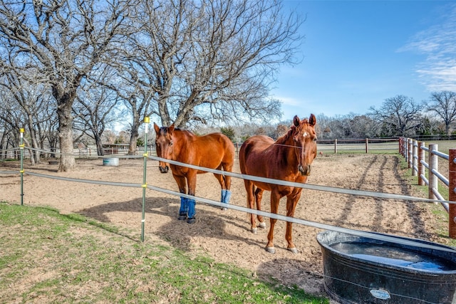 view of horse barn featuring a rural view