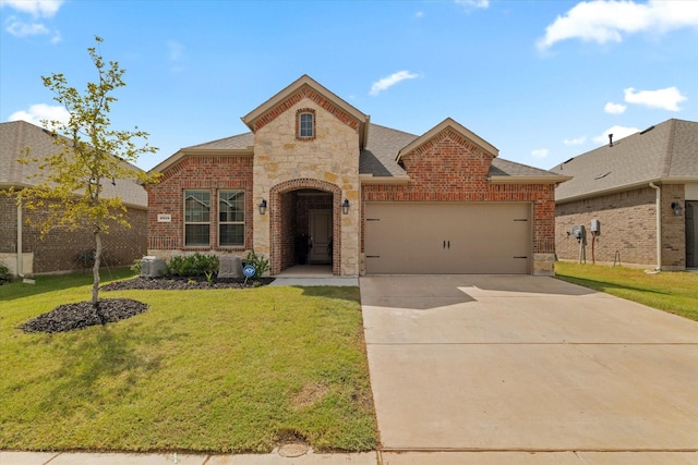 view of front of property featuring a garage and a front lawn