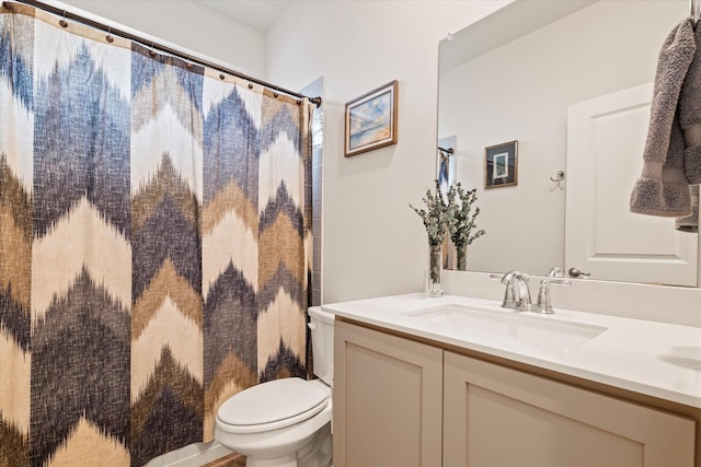 bathroom with vanity, toilet, and curtained shower