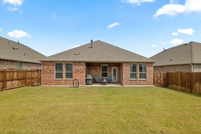 rear view of property featuring a lawn and a patio area