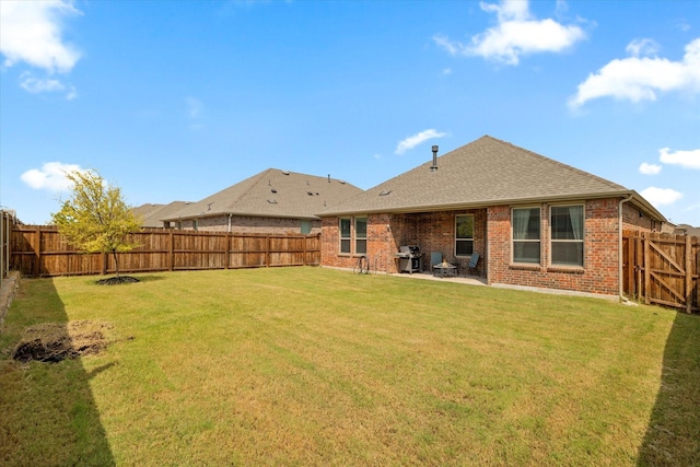 rear view of property with a lawn and a patio area