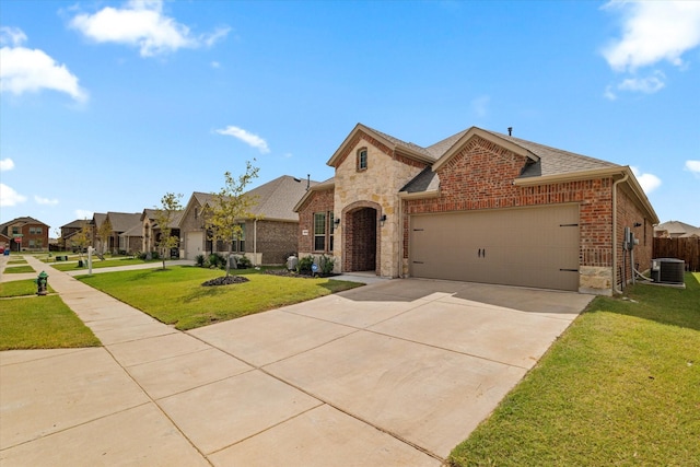 view of front of property featuring central AC unit, a garage, and a front lawn