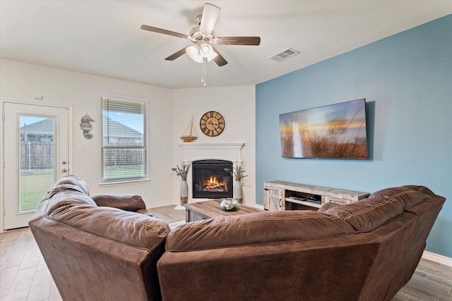 living room featuring light hardwood / wood-style flooring and ceiling fan