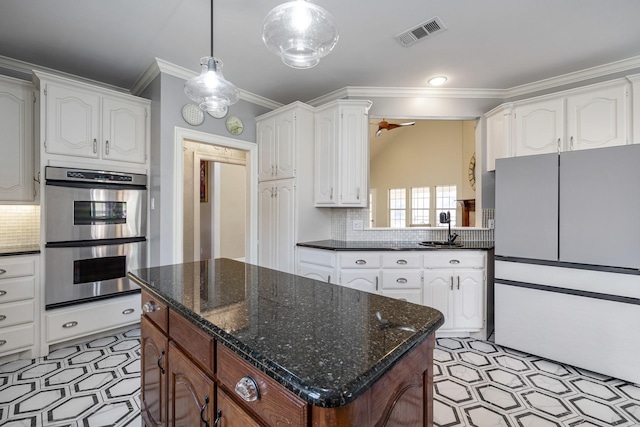 kitchen with sink, white cabinets, and double oven