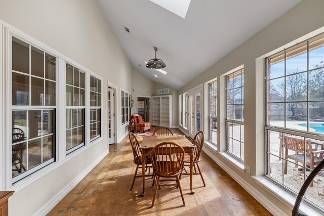 sunroom featuring lofted ceiling with skylight