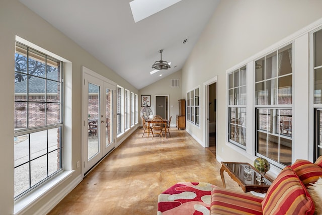 sunroom / solarium featuring french doors, lofted ceiling with skylight, and a wealth of natural light