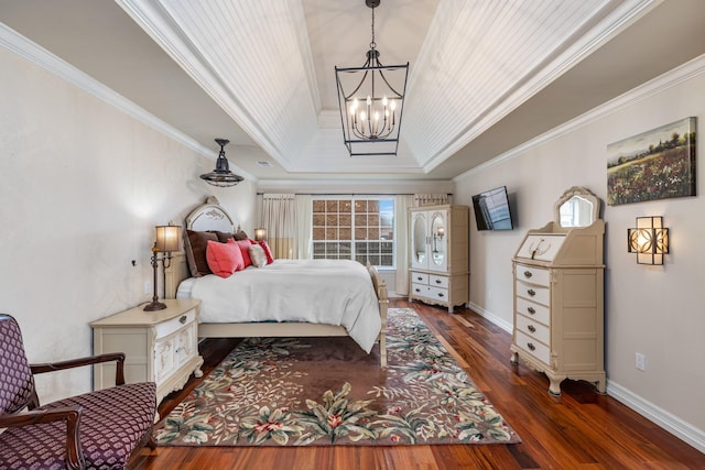 bedroom featuring dark hardwood / wood-style flooring, ornamental molding, a raised ceiling, and a chandelier