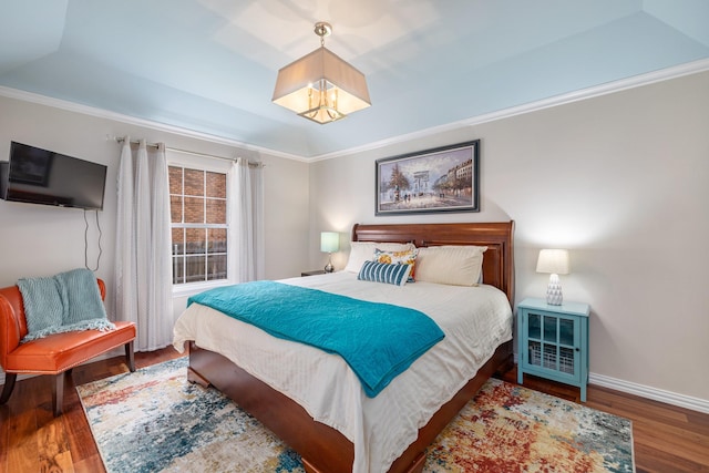 bedroom featuring ornamental molding and dark hardwood / wood-style floors