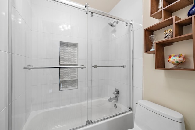 bathroom featuring shower / bath combination with glass door and toilet