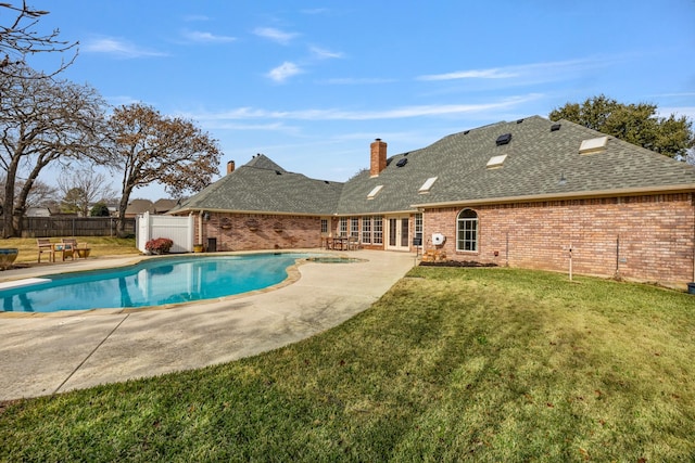 view of pool with a diving board, a lawn, french doors, and a patio area