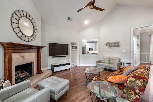 living room with a high end fireplace, wood-type flooring, high vaulted ceiling, and ceiling fan