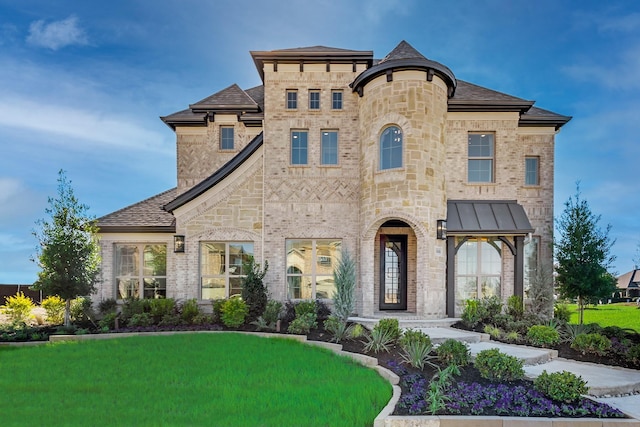 french country style house with a front lawn