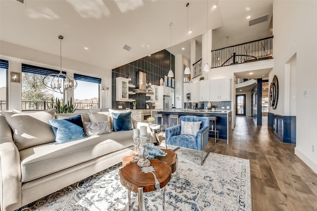 living room featuring a chandelier and wood-type flooring