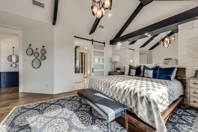 bedroom featuring beamed ceiling, a barn door, wood-type flooring, and high vaulted ceiling