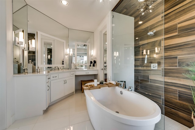 bathroom featuring tile patterned flooring, shower with separate bathtub, vanity, and tile walls