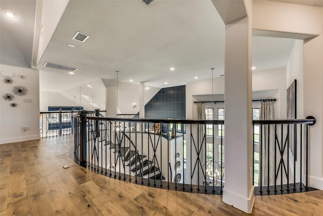 hallway featuring hardwood / wood-style floors and lofted ceiling