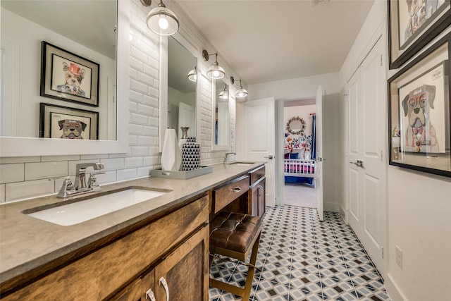 bathroom with tasteful backsplash and vanity