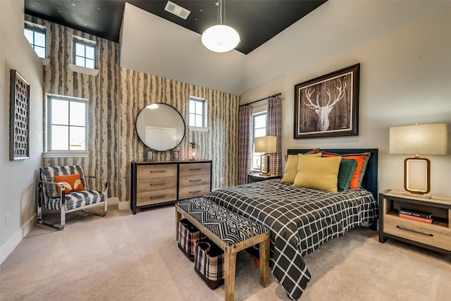 bedroom featuring a high ceiling and carpet floors