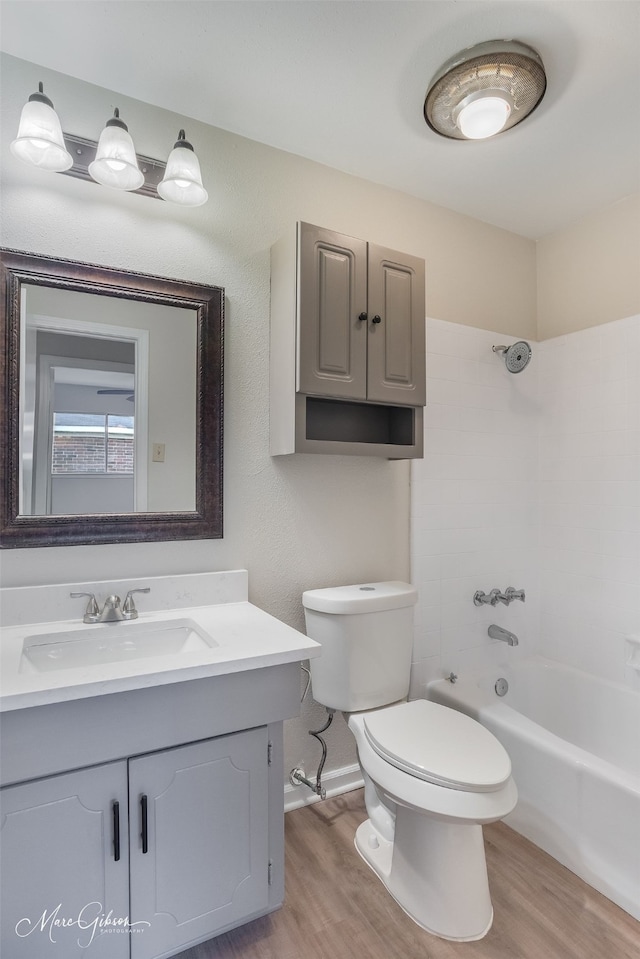 full bathroom featuring hardwood / wood-style floors, vanity, toilet, and shower / bath combination