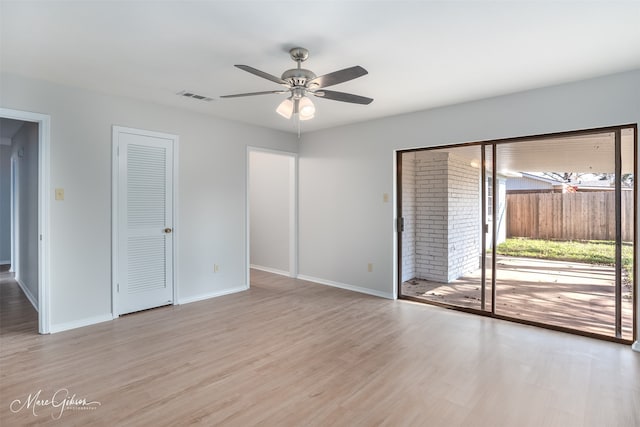 spare room with light wood-type flooring and ceiling fan