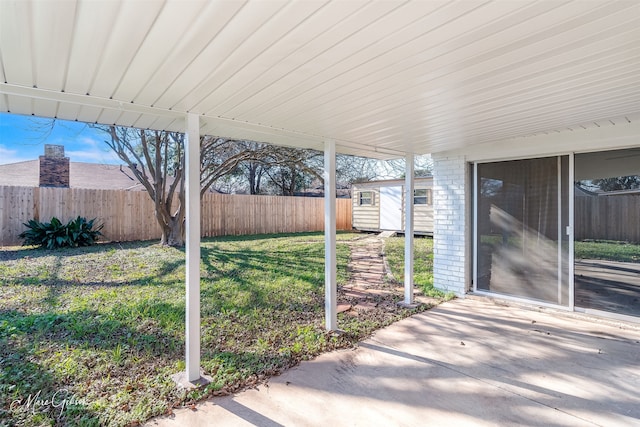 view of patio featuring a shed