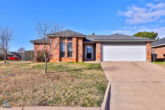 view of front of home with a front lawn and a garage