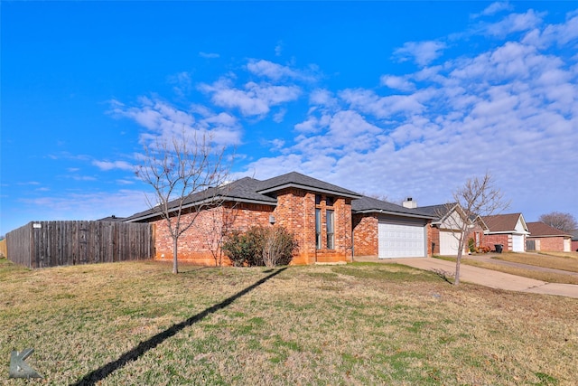 view of front of house featuring a garage and a front yard