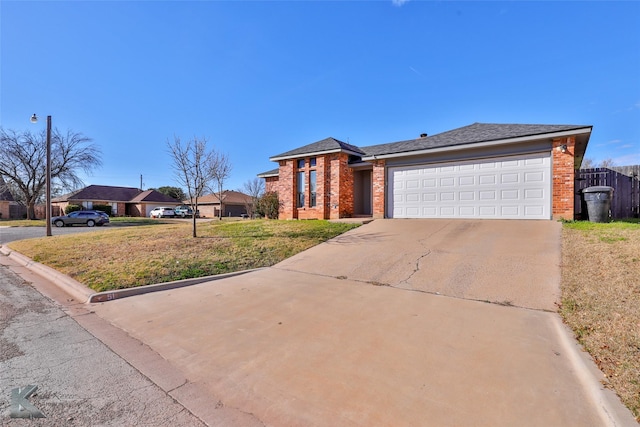 ranch-style home featuring a garage and a front lawn