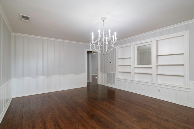 unfurnished dining area with a chandelier, dark hardwood / wood-style flooring, built in features, and crown molding