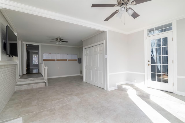 unfurnished room with ceiling fan, light tile patterned floors, and ornamental molding