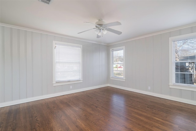 empty room with ceiling fan, crown molding, and dark wood-type flooring