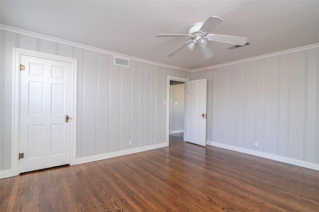 unfurnished room featuring ceiling fan, dark hardwood / wood-style flooring, and crown molding