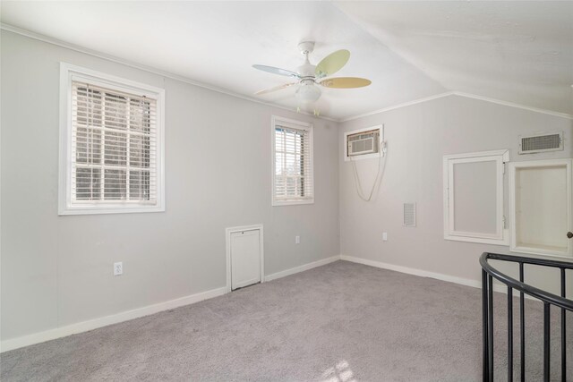 empty room featuring light carpet, ornamental molding, ceiling fan, an AC wall unit, and lofted ceiling