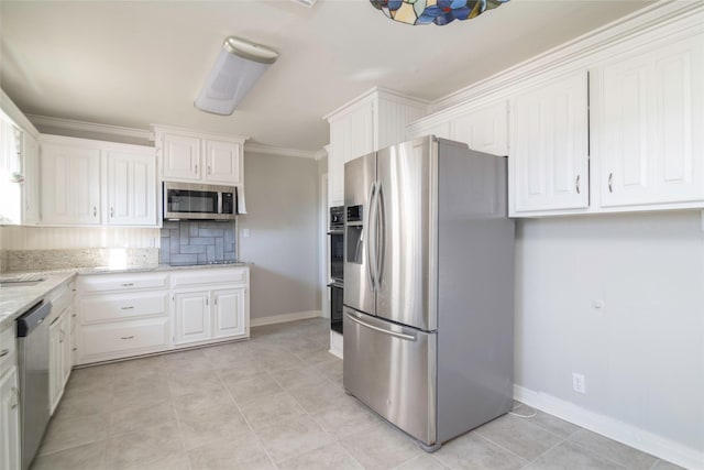 kitchen featuring backsplash, light stone countertops, white cabinets, and appliances with stainless steel finishes